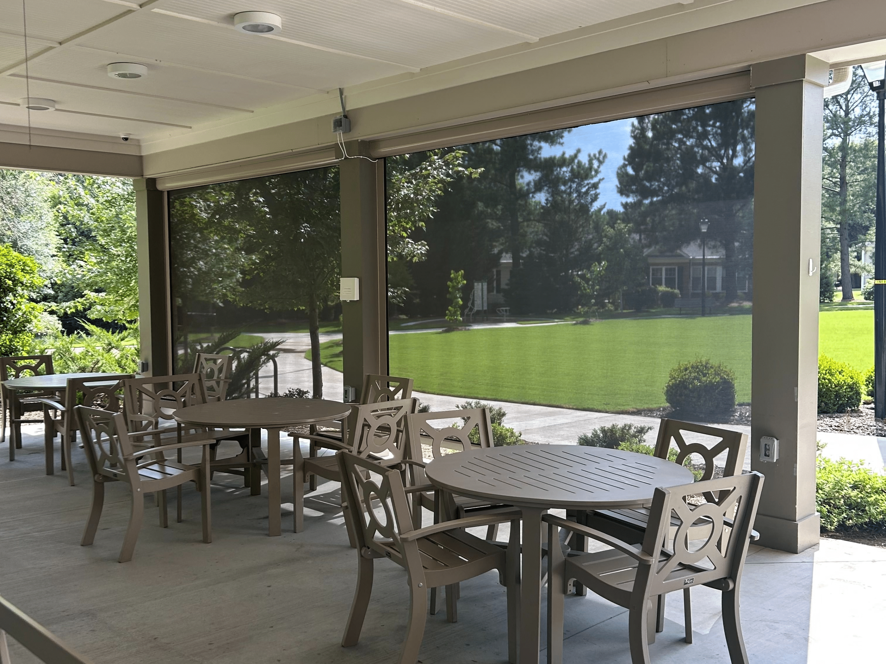 Exterior Shades Exterior shades filtering in natural light to an outdoor seating area.