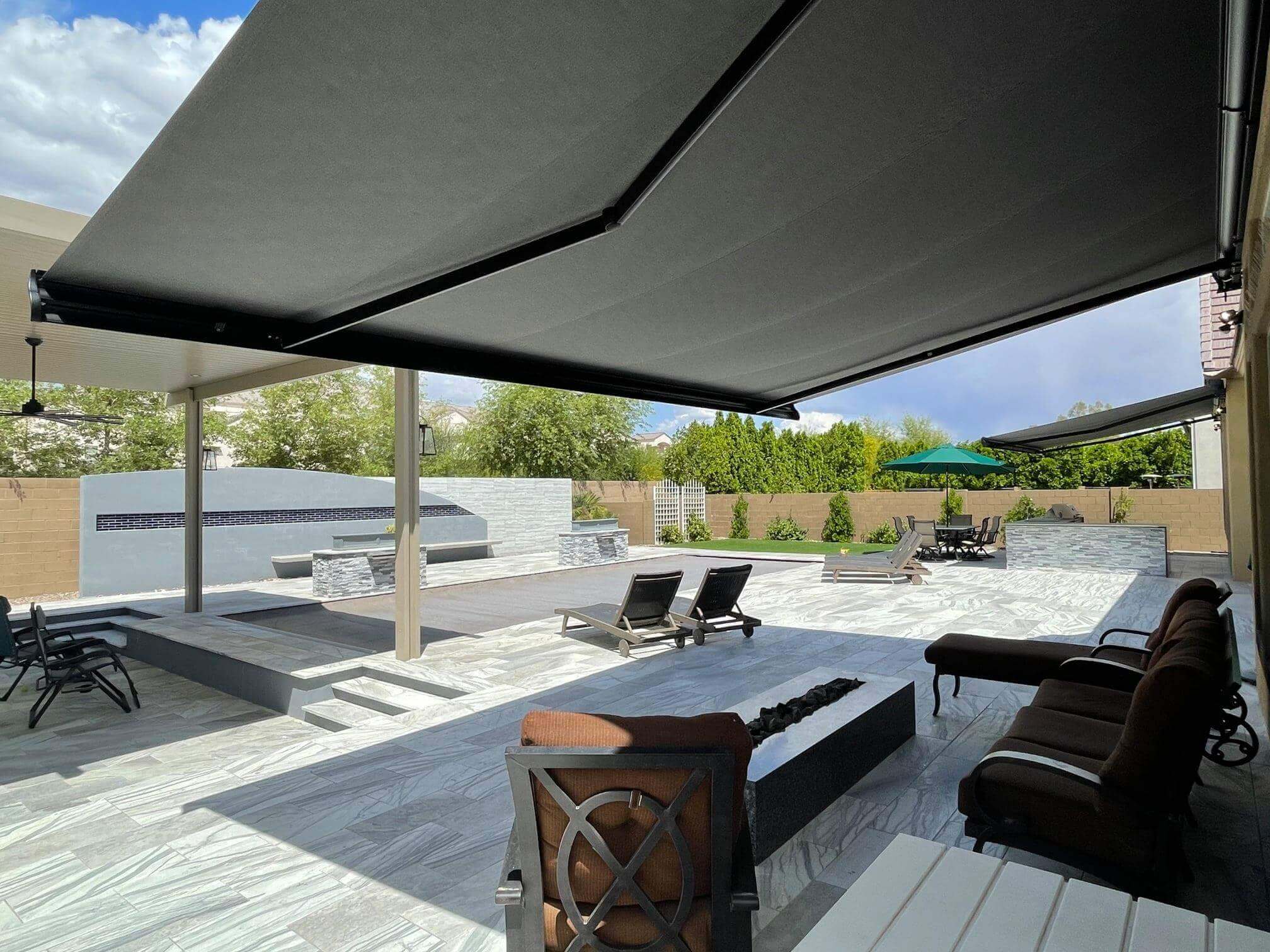 A fully extended awning covering a back patio.