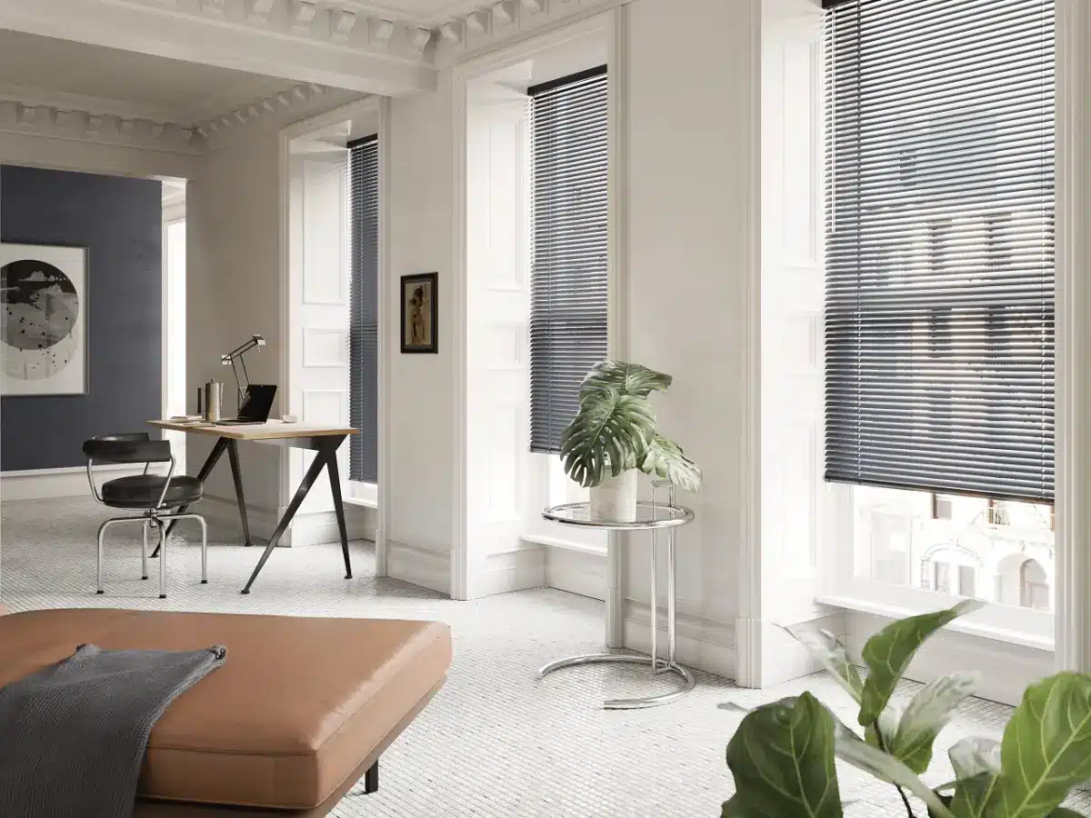 Modern home office with floor-to-ceiling charcoal aluminum blinds overlooking a city skyline in Venice, FL