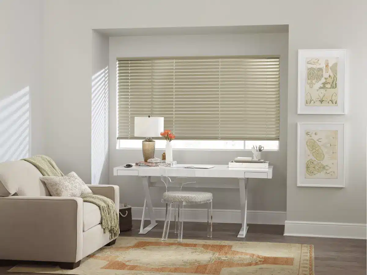 Modern home office with gray aluminum blinds covering a large window above a white desk in Venice, FL