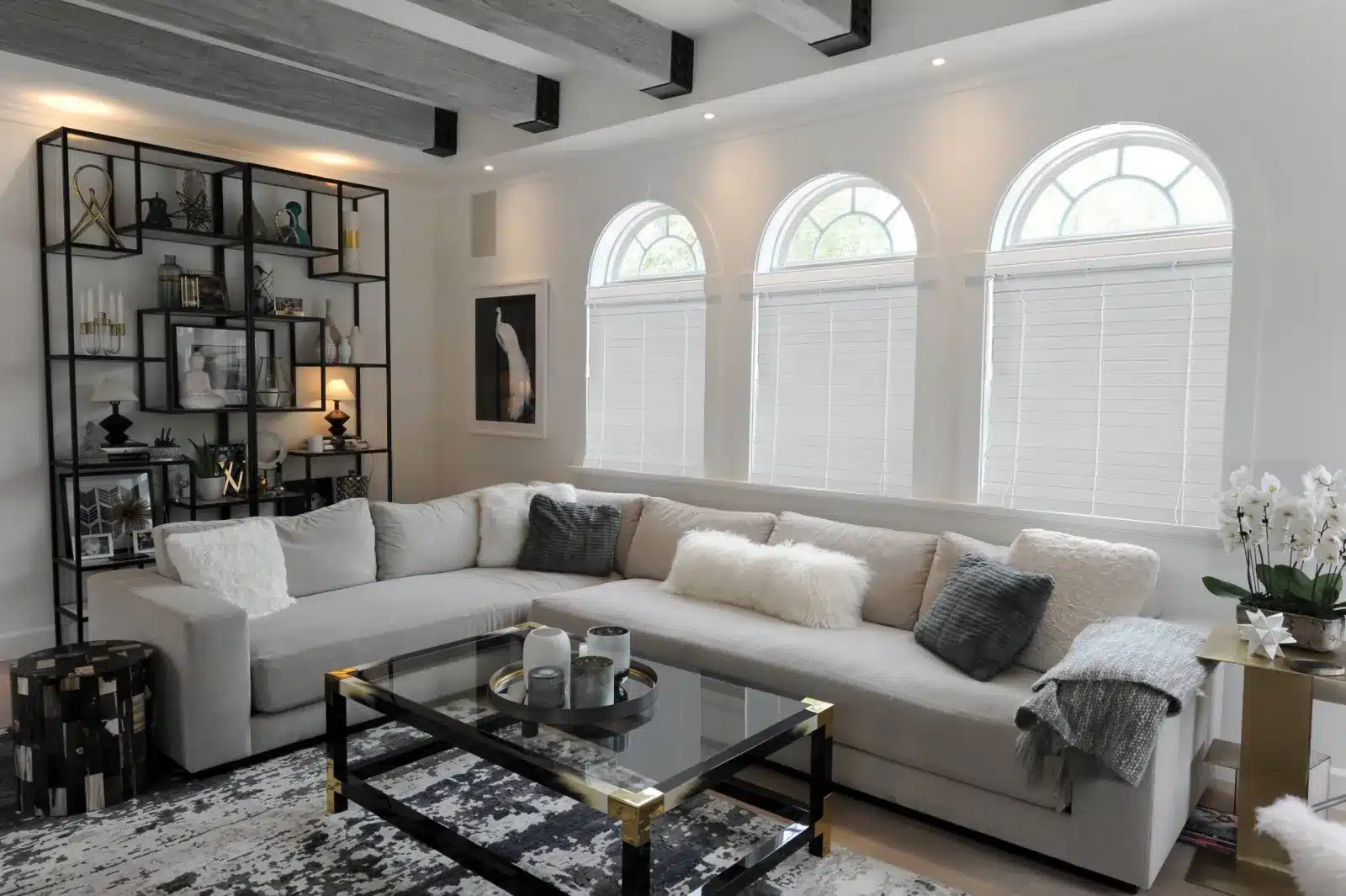Modern living room with cellular shades on three arched windows above a sectional sofa in Venice Modern living room with cellular shades on three arched windows above a sectional sofa in Venice