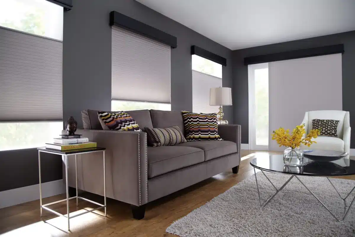 Modern living room with gray cellular shades and blackout capabilities on multiple windows in Venice, FL