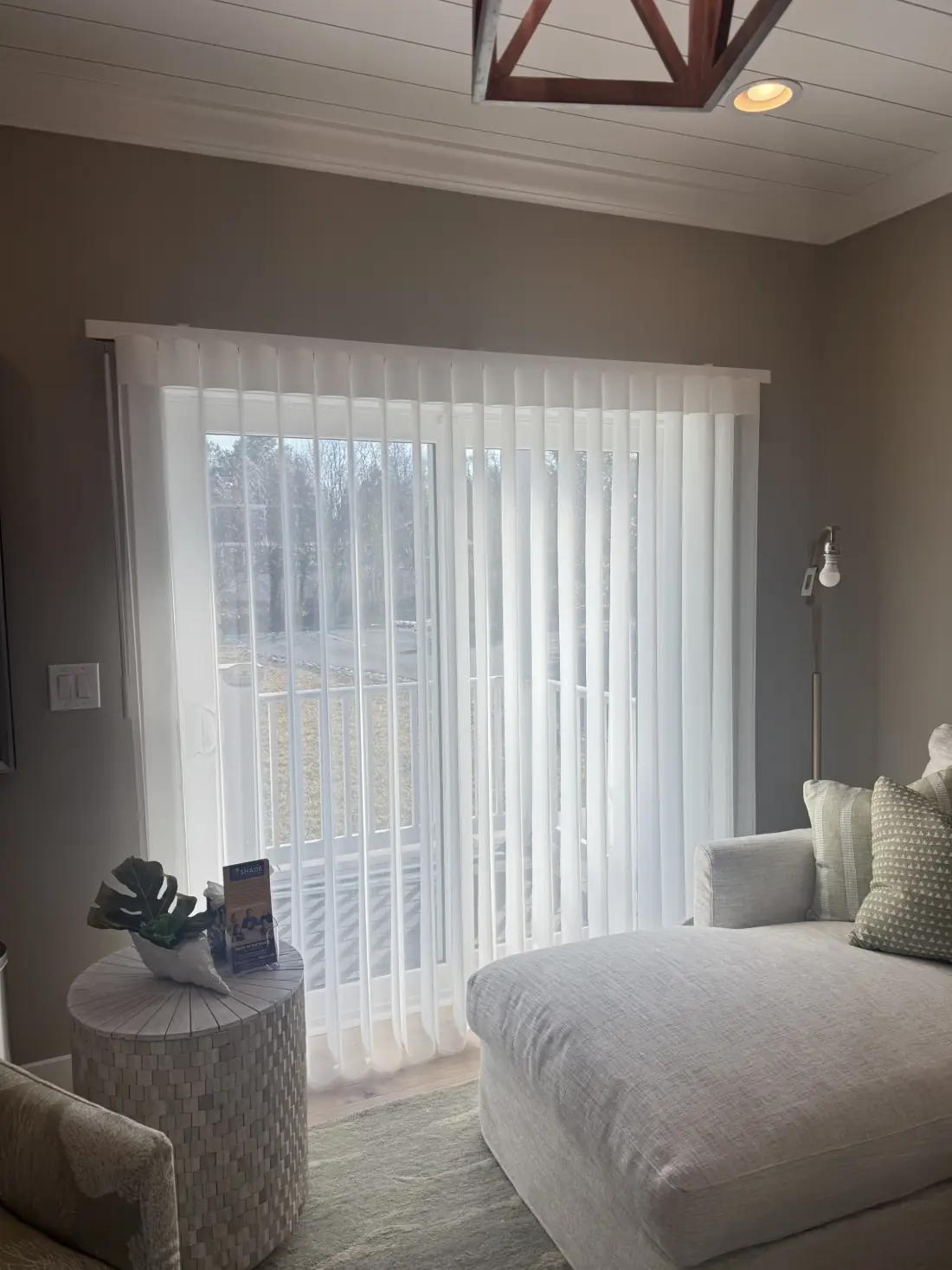 Bright white vertical drapes frame sliding glass doors in a modern bedroom with neutral furnishings in Venice Bright white vertical drapes frame sliding glass doors in a modern bedroom with neutral furnishings in Venice