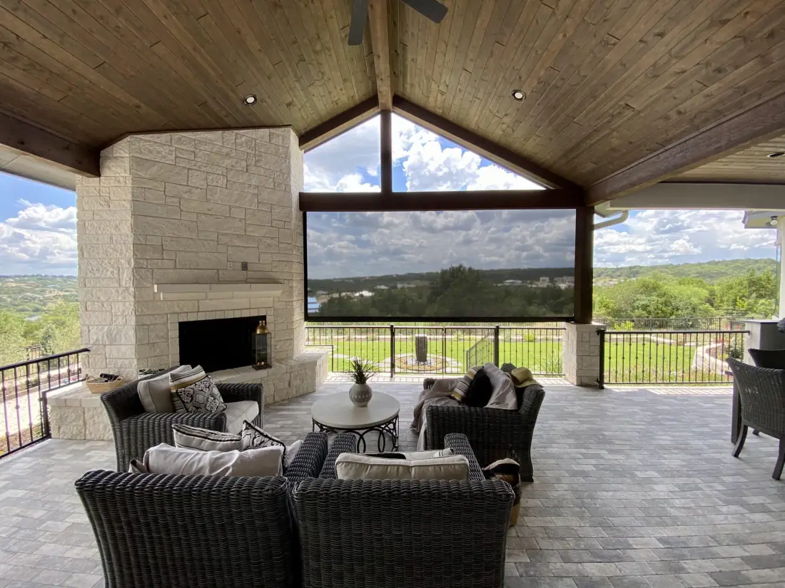 Covered patio with exterior shades on large windows overlooking rolling hills and landscape in Venice, FL