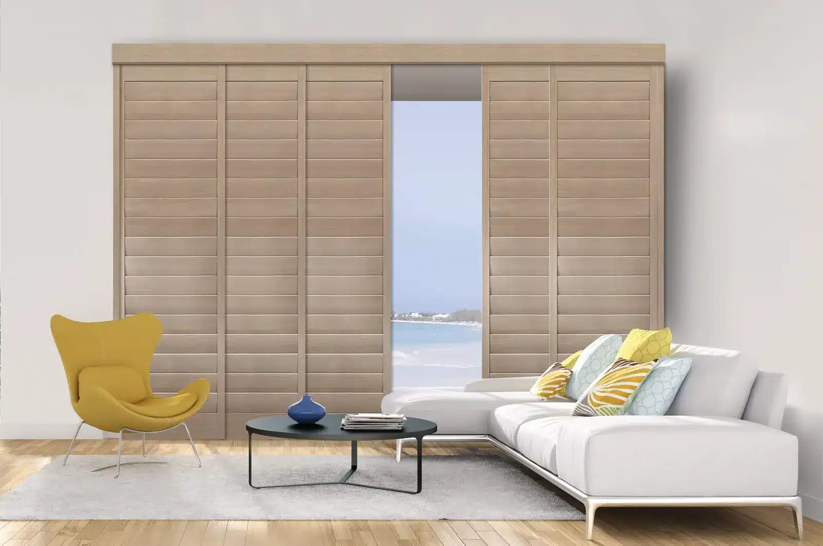 Modern living room with tan plantation shutters framing an ocean view, yellow accent chair, and white in Venice, FL Modern living room with tan plantation shutters framing an ocean view, yellow accent chair, and white in Venice, FL