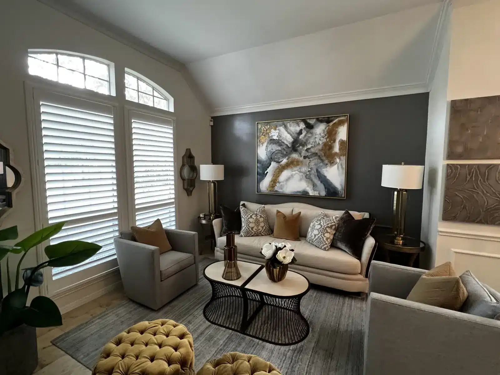 Bright living room with white plantation shutters on large windows, featuring contemporary furnishings and dark in Venice