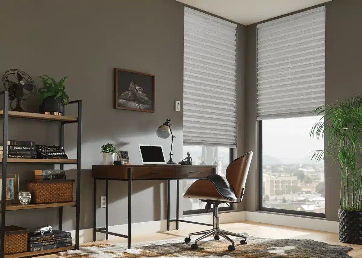 Pleated shades in a modern home office with corner windows overlooking a city skyline in Venice, FL