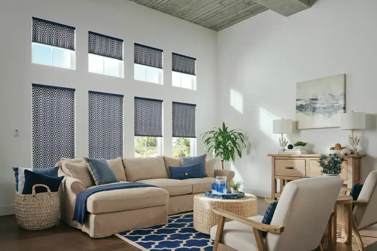 Coastal living room with geometric patterned roller shades and neutral furnishings in Venice, FL