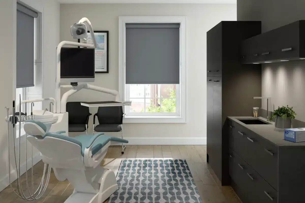 Charcoal roller shades in a modern dental treatment room with clinical equipment in Venice, FL