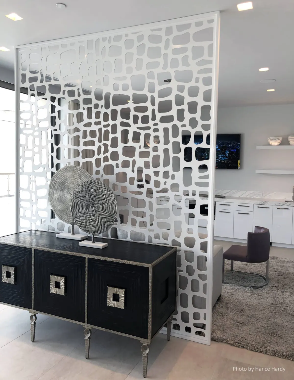 White decorative lattice panel room divider with geometric pattern in modern showroom setting in Venice, FL
