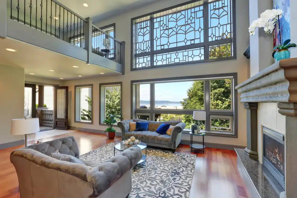Elegant living room with decorative window grilles framing a waterfront view through large windows in Venice, FL