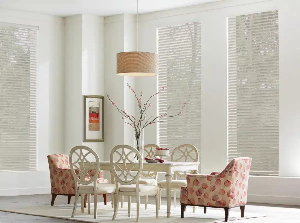 Dining room with woven window shades filtering natural light through large windows in Venice, FL