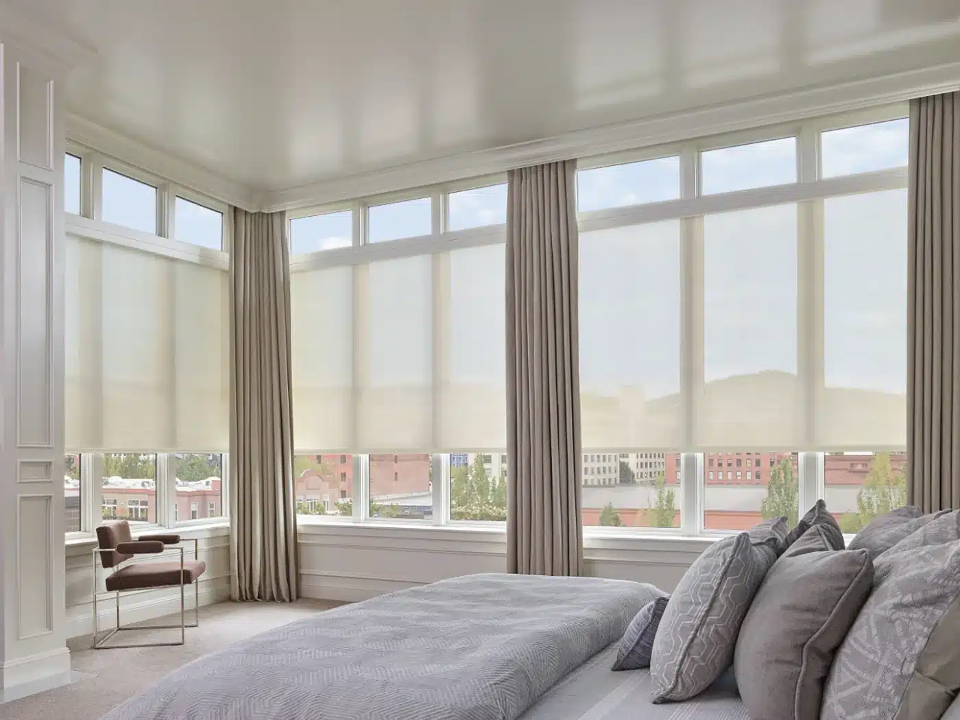 Cream solar shades and drapes in a Venice, FL bedroom