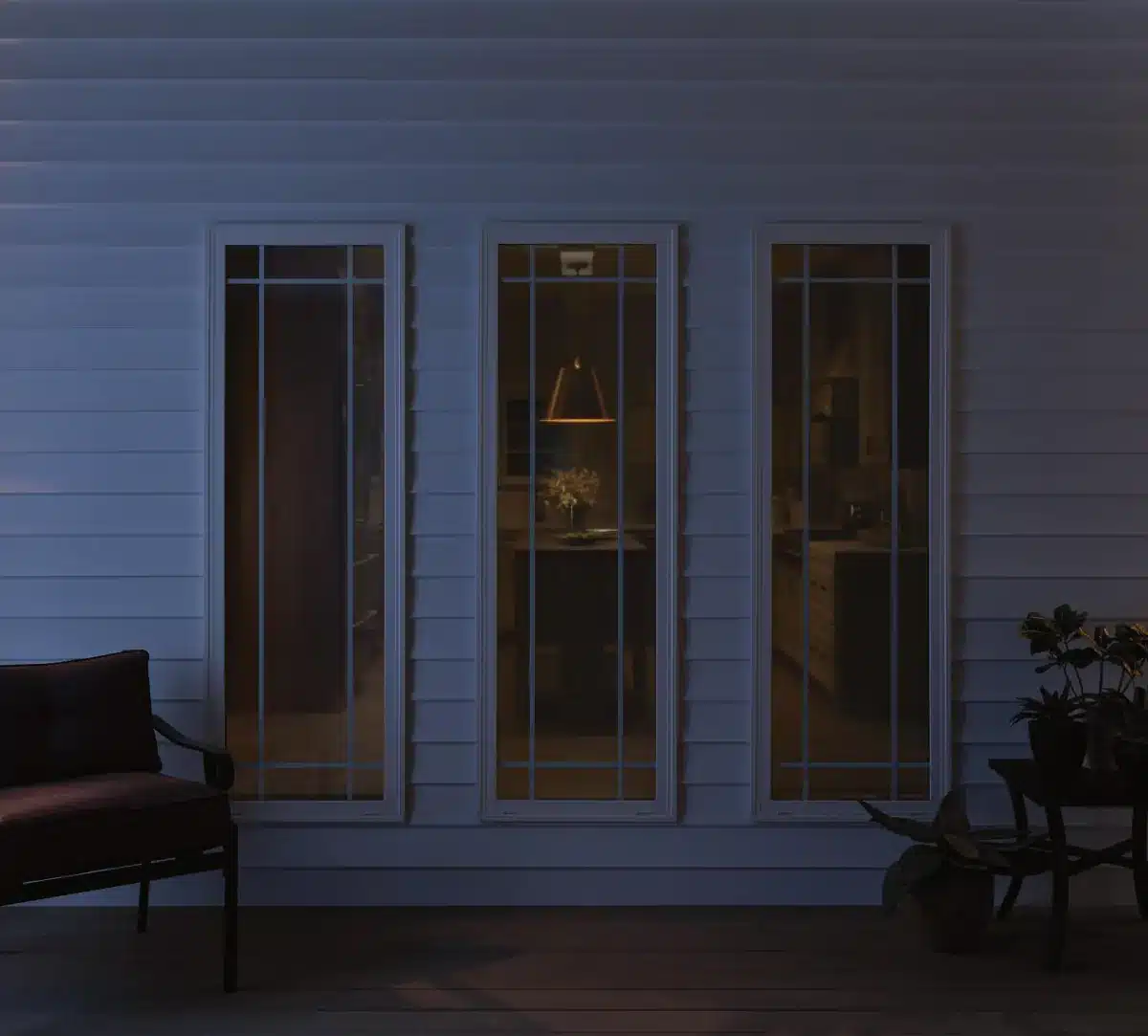 Three large solar shades on a patio at dusk with interior lighting visible through the fabric in Venice, FL