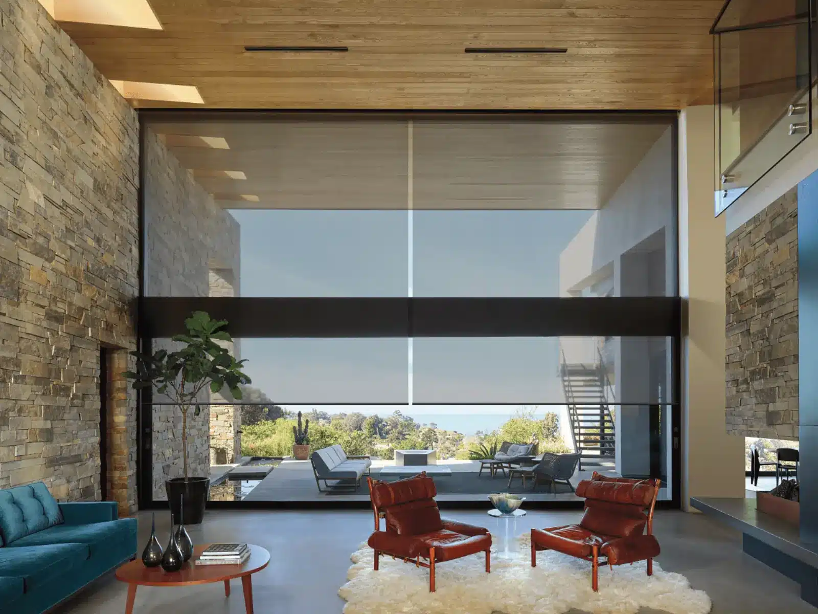 Modern living room with large solar shades filtering sunlight over expansive outdoor views in Venice Modern living room with large solar shades filtering sunlight over expansive outdoor views in Venice