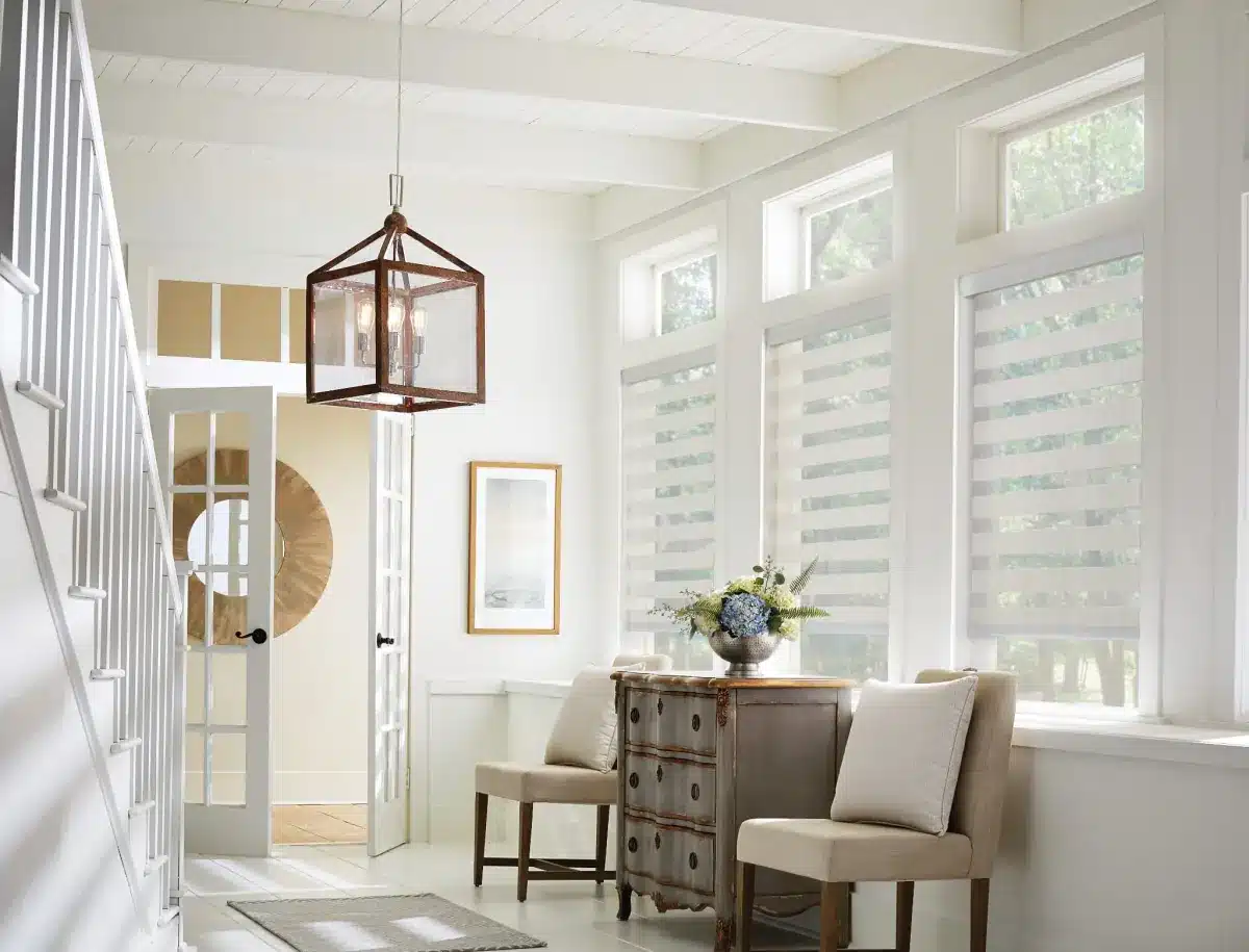 Bright entryway with layered white solar shades filtering natural light through tall windows in Venice, FL