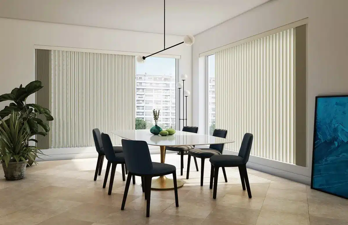Modern dining room with cream vertical blinds framing floor-to-ceiling windows overlooking the city in Venice, FL