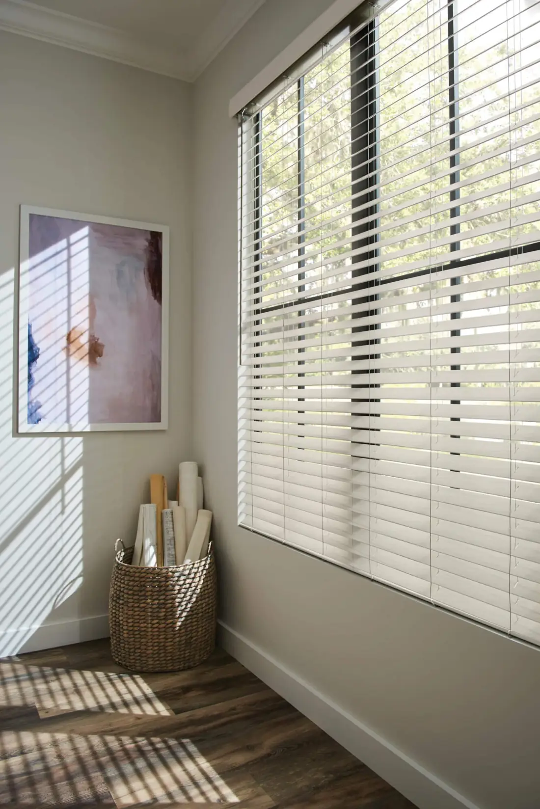 Bright corner room with white wood blinds filtering natural light onto hardwood floor in Venice, FL