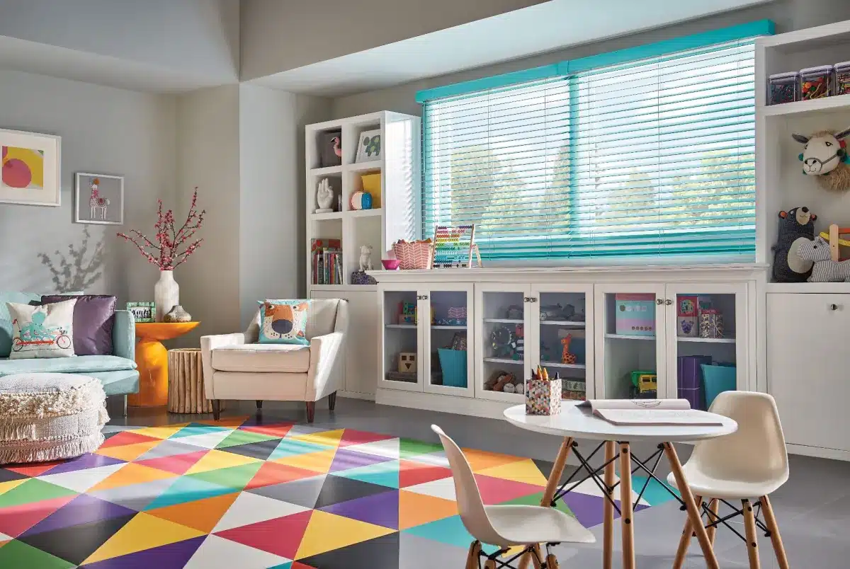 Turquoise blinds on a large window in a colorful children's playroom with storage in Venice, FL