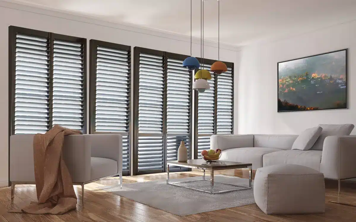 Modern living room with white plantation shutters lining large windows and contemporary furniture in Venice, FL